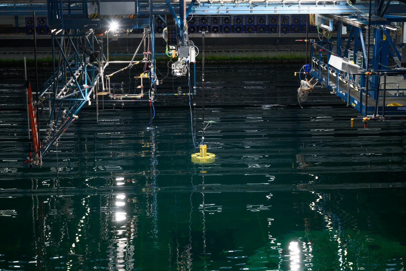 Wide view of the MARIN test basin showing the ECO TLP 15 MW foundation scale model, overhead test equipment and measurement rig.
